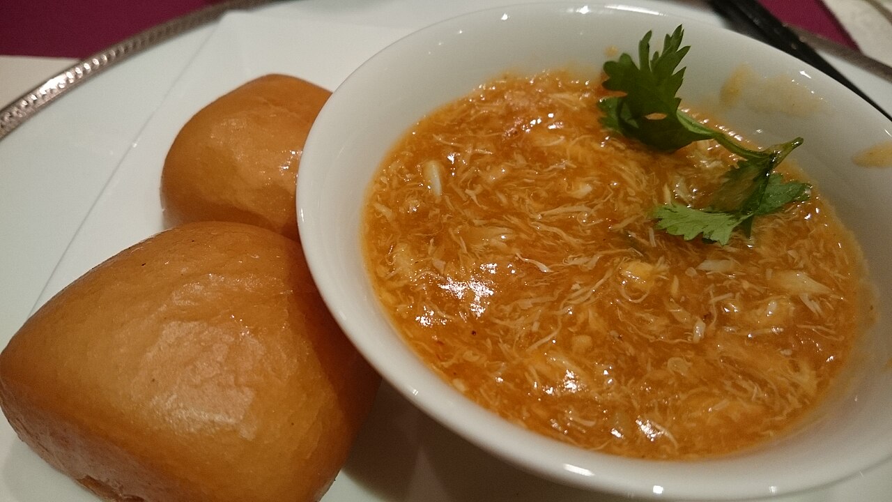 Leftover chilli crab sauce served with bread rolls for mopping, a Singapore seafood-meal staple