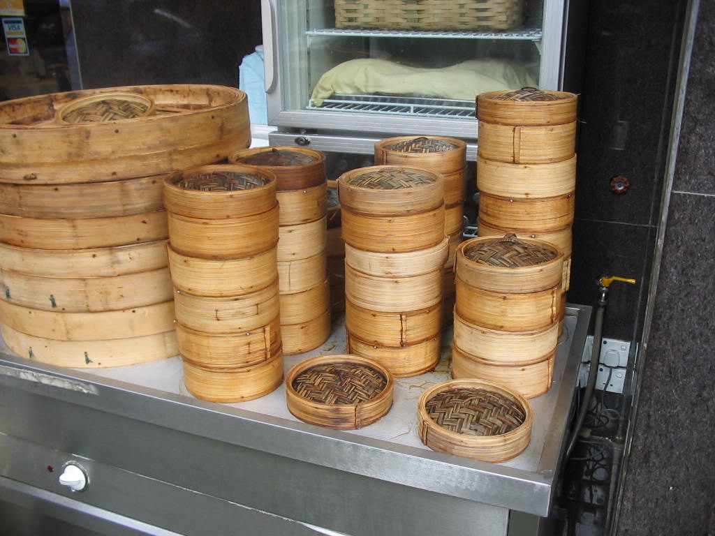 Stacked bamboo steamers full of dim sum dishes